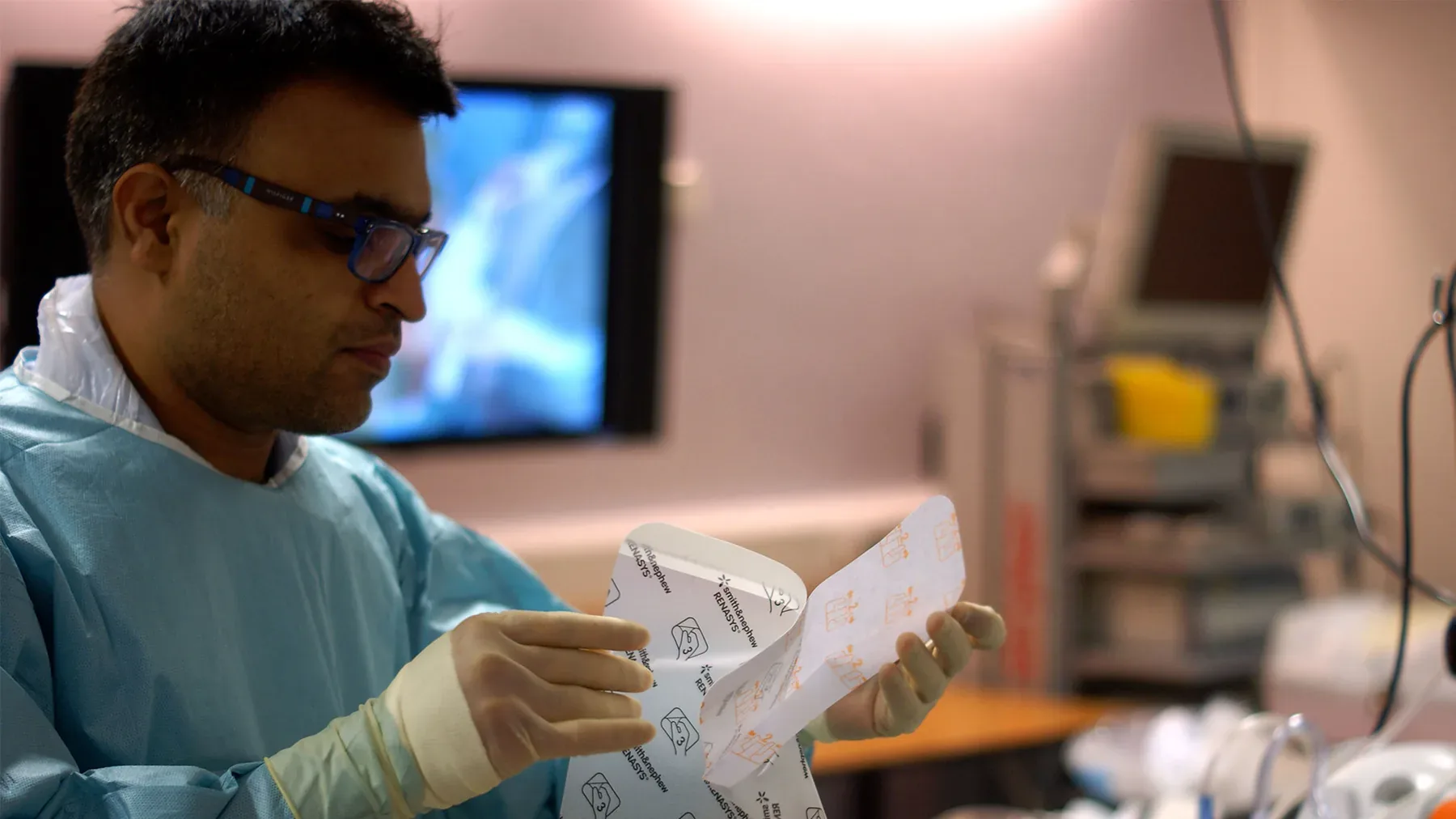 Surgeon closely examining Smith & Nephew RENASYS product packaging